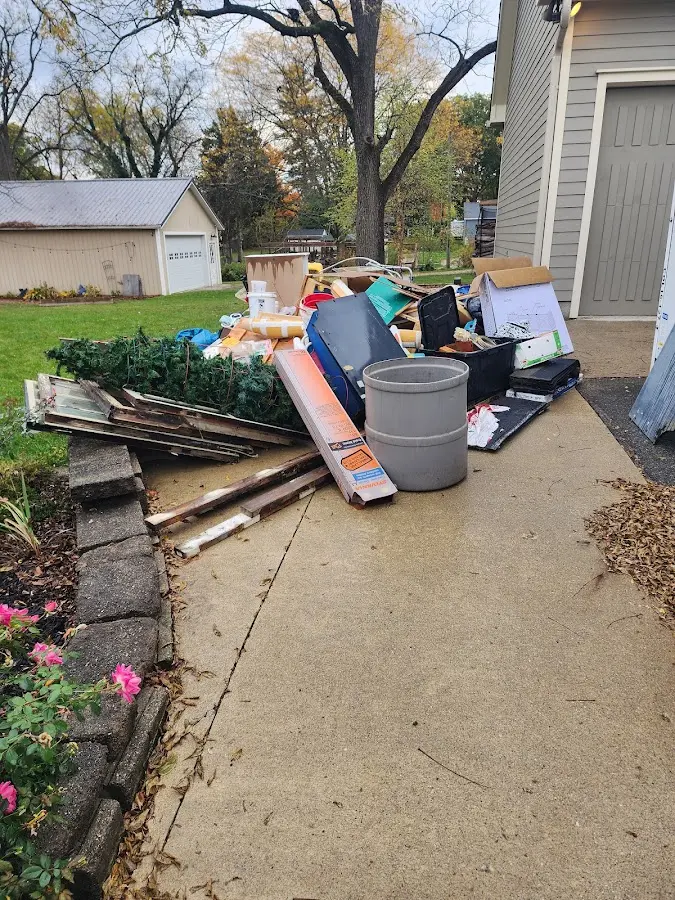 Dumpster being loaded with debris for 3 Yard Dumpster Rental in Platte City